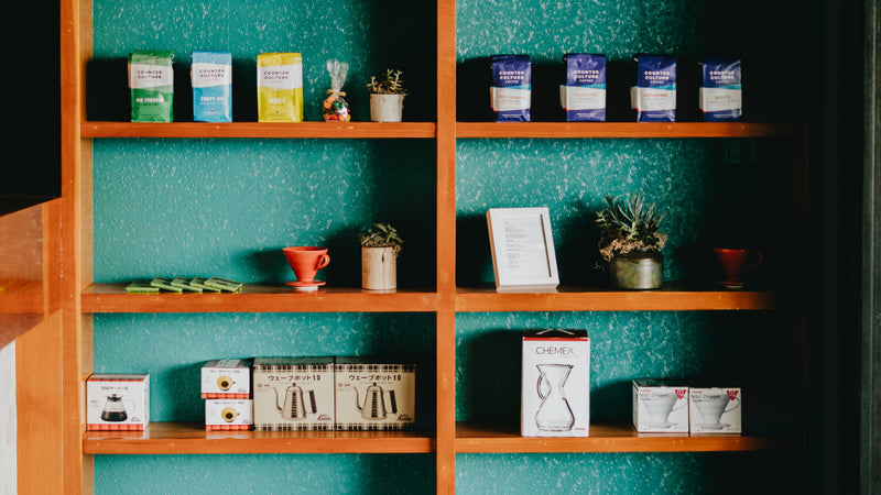 Coffee bags and retail items on the shelf at a cafe