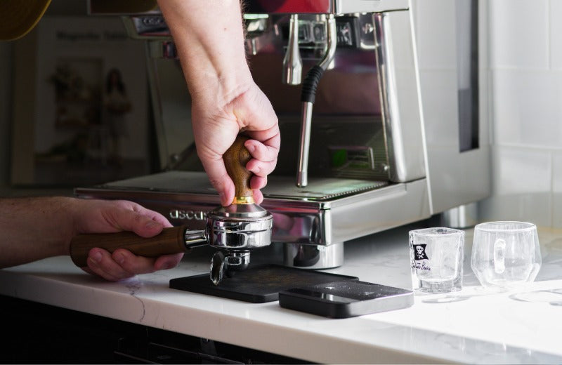 Tamping a puck for an espresso machine